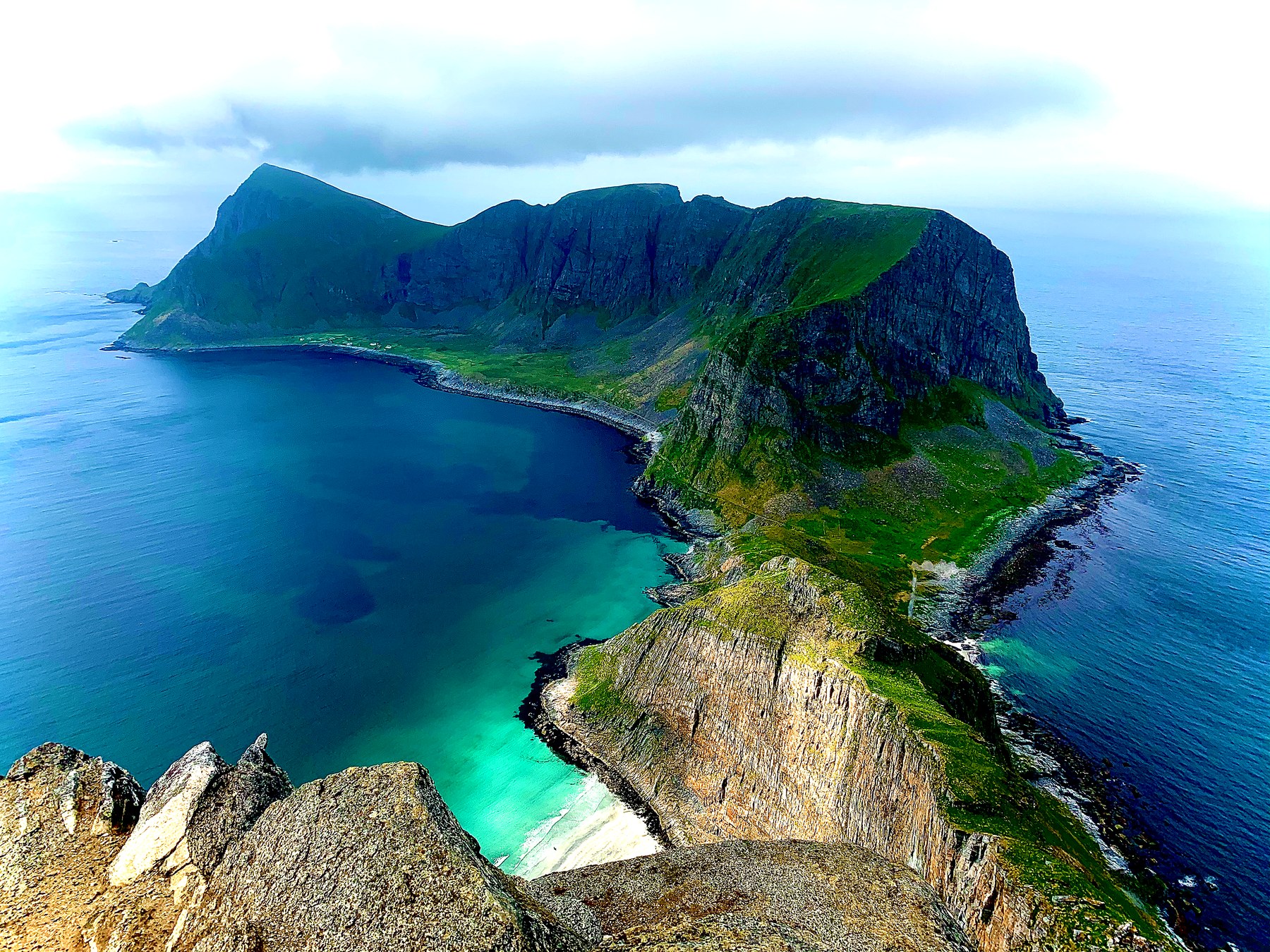 View from Håen on Værøy, with turquoise sea and a white sandy beach